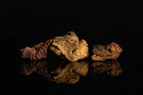 Mixed fruit tea isolated on black glass Stock Photos