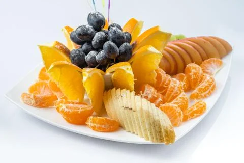 Mixed fruit in white plate isolated on white background - Healthy food style Stock Photos