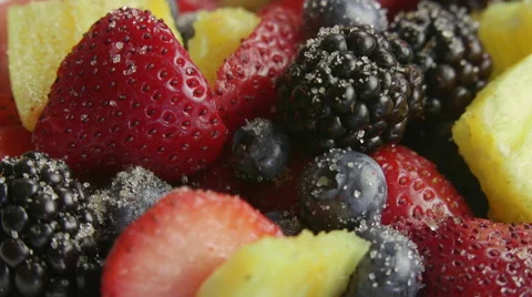 Mixed Fruits on Rotating Table Covered in Sugar Stock Footage 65797939
