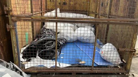 Mixed garbage in large quantities in the construction container. Stock Photos