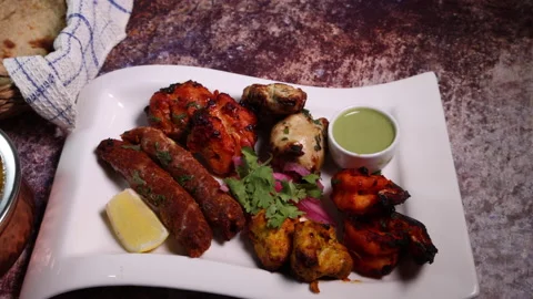 Mixed grill kebab chicken mutton beef prawn fish mint sauce lemon pickled onion  Stock Footage 150988006