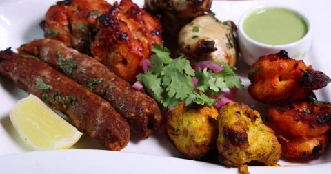 Mixed grill kebab chicken mutton beef prawn fish mint sauce lemon pickled oni Stock Footage 150988140
