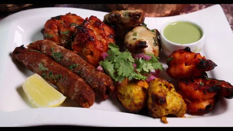Mixed grill kebab chicken mutton beef prawn fish mint sauce lemon pickled onion  Stock Footage 150988179