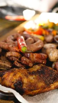 Mixed grilled meat platter. Assorted delicious grilled meat with vegetable. Stock Photos