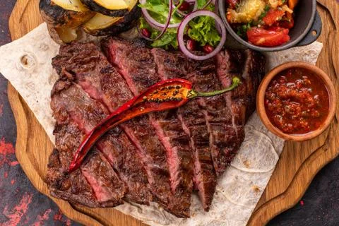 Mixed grilled meat platter. Assorted delicious grilled meat with vegetable. M Stock Photos