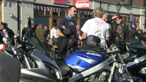 Mixed group of people talking by parked motorbikes Stock Footage 37096934