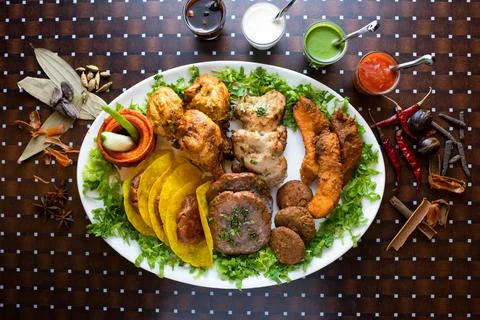 Mixed kabab platter with seekh kabab, tikka, boti raita, mint, sauce, chutney Stock Photos