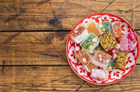 Mixed lokum candy cubesin eastern plate on wooden background. Handmade conf.. Stock Photos
