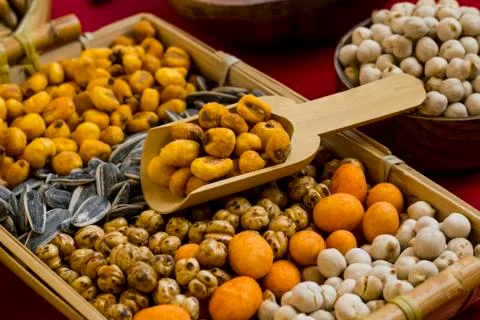 Mixed luxury nuts designed on a wicker tray with wooden shovel Stock Photos