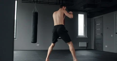 Mixed martial art fighter does shadow boxing and trains at fighter club, fighter Stock Footage 153597898