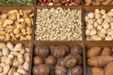 Mixed nut background: pine nuts, pistachios, cashews, almonds, hazelnuts, p.. Stock Photos