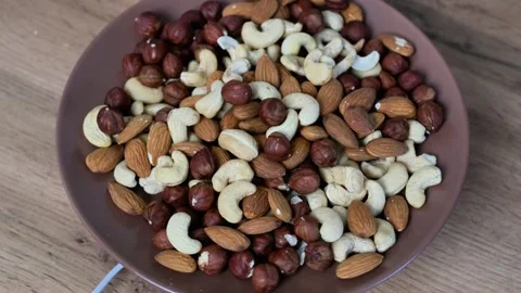 Mixed nuts of almonds, cashews, and hazelnuts Stock Footage 332153052