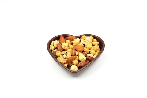 Mixed nuts in bowl. Mix of various nuts on white background. Stock Photos