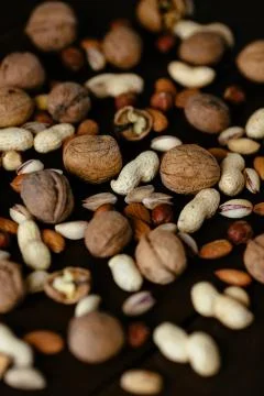 Mixed nuts. Group of mixed nuts on black background Stock Photos