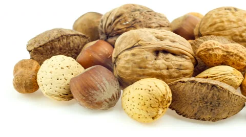 Mixed nuts isolated on white sliding in and out of frame in slow pan Stock Footage 47431904