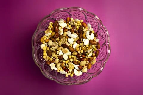 Mixed nuts on pink background Stock Photos