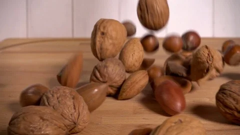 Mixed nuts in shells falling in slow motion Stock Footage 77565215