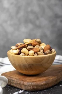 Mixed nuts. Special mixed nuts in wooden bowl. Hazelnut, almond, cashew, pist Stock Photos