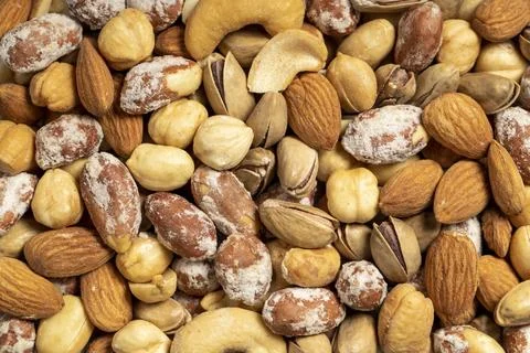 Mixed nuts. Special mixed nuts in a wooden bowl. Nuts, pistachios, peanuts, c Stock Photos