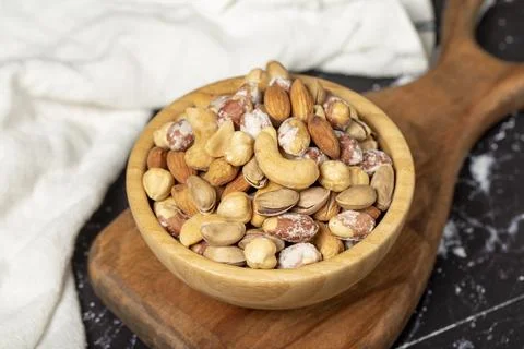 Mixed nuts. Special mixed nuts in a wooden bowl. Nuts, pistachios, peanuts, c Stock Photos