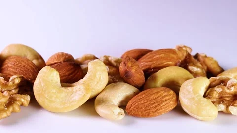 Mixed nuts on white background, rotating Stock Footage 313815551