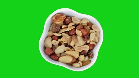 Mixed nuts in white bowl rotating on the green screen Stock Footage 134895107