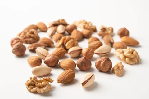 Mixed nuts on a white surface Stock Photos