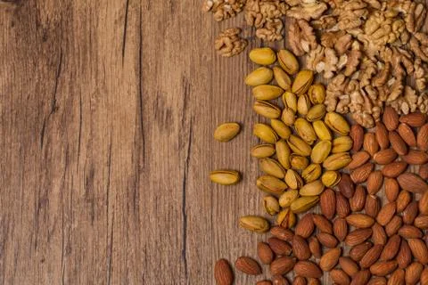 Mixed nuts on wooden background - Nuts frame top view Stock Photos
