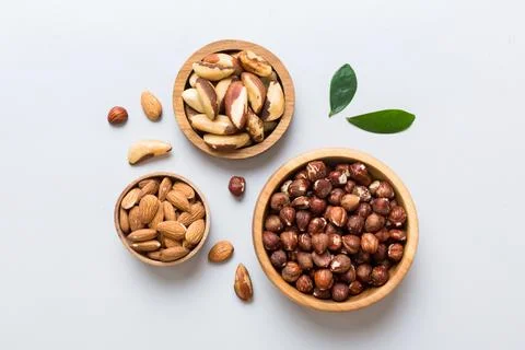 Mixed nuts in wooden bowl. Mix of various nuts on colored background. pista.. Stock Photos