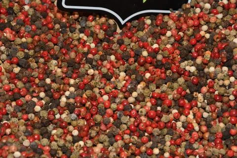 Mixed peppercorns background. Different colored peppercorns, close up. Stock Photos