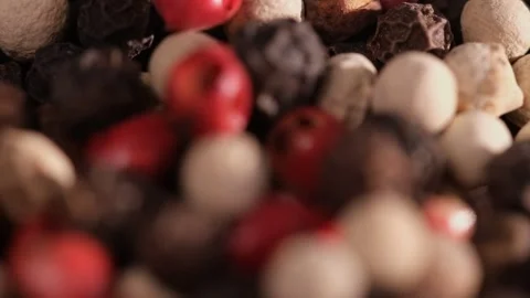 Mixed peppercorns falling in rotation, heap of spice, mix of different peppers Stock Footage 166387355