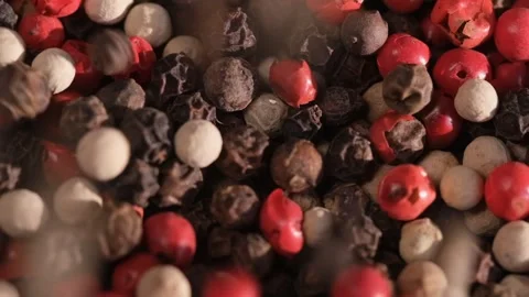 Mixed peppercorns falling in rotation, heap of spice, mix of different peppers Stock Footage 166389878