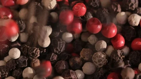 Mixed peppercorns falling in rotation, heap of spice, mix of different peppers Stock Footage 166389929