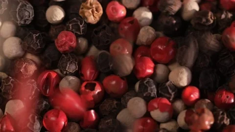 Mixed peppercorns falling in rotation, heap of spice, mix of different peppers Stock Footage 166389961