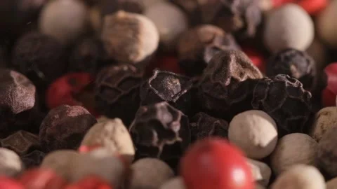 Mixed peppercorns falling in rotation, heap of spice, mix of different peppers Stock Footage 166389992