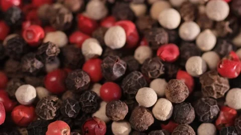 Mixed peppercorns falling in rotation, heap of spice, mix of different peppers Stock Footage 166454691