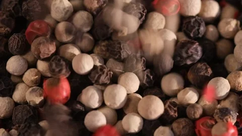 Mixed peppercorns falling in rotation, heap of spice, mix of different peppers Stock Footage 166455525