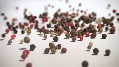 Mixed peppercorns falling in slow motion Stock Footage 76564113