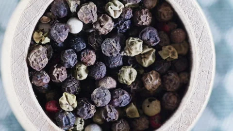 Mixed peppercorns in small bowl rotating close-up Stock Footage 344948260