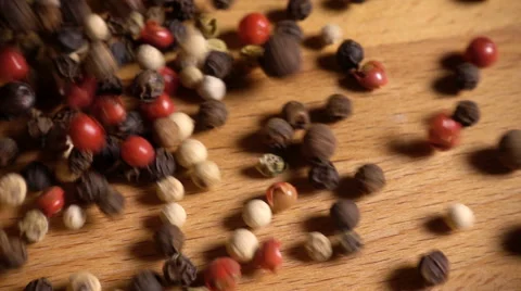 Mixed peppercorns spill onto table, slow motion Stock Footage 61694278