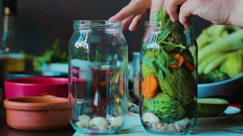 Mixed pickle preparation, vegetables are placed in jars Stock Footage 249815465