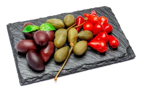 Mixed Pickles on stone serving board. Olives, Capers and peppers Foto stock