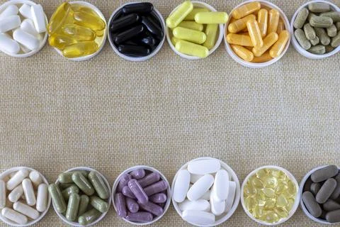 Mixed pill background, top view. Nutritional supplements, vitamins and organic Stock Photos