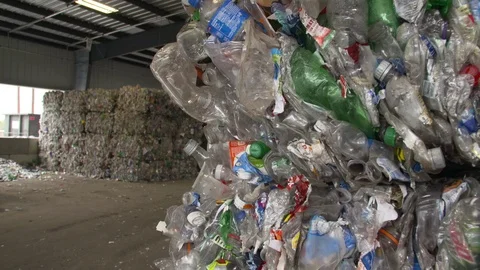 Mixed plastic bottles baled in warehouse and ready for recycling Stock Footage 93530217