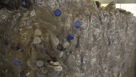Mixed plastic bottles baled in warehouse and ready for recycling Stock Footage 93530229