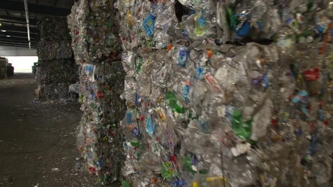 Mixed plastic bottles baled in warehouse and ready for recycling Stock Footage 93530256