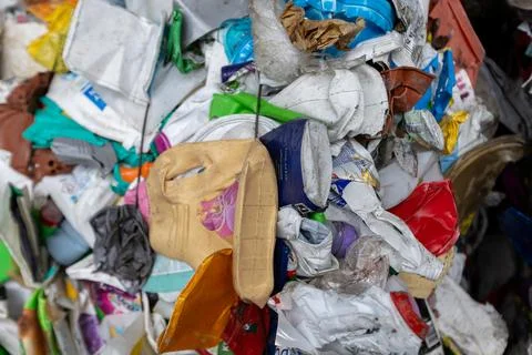 Mixed plastic waste prepared for sorting at recycling facility 库存照片