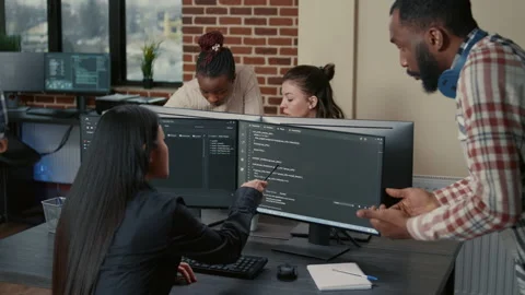 Mixed programmers team working on group project on multiple screens showing Stock Footage 168247821