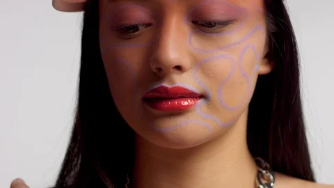 Mixed race asian model in studio creative art makeup Stock Footage 110732552