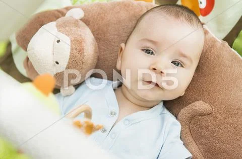 Mixed Race Baby Laying On Pillow